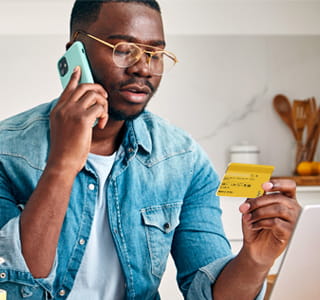 man on phone with credit card
