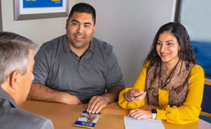 Golden 1 members at desk being helped by an employee