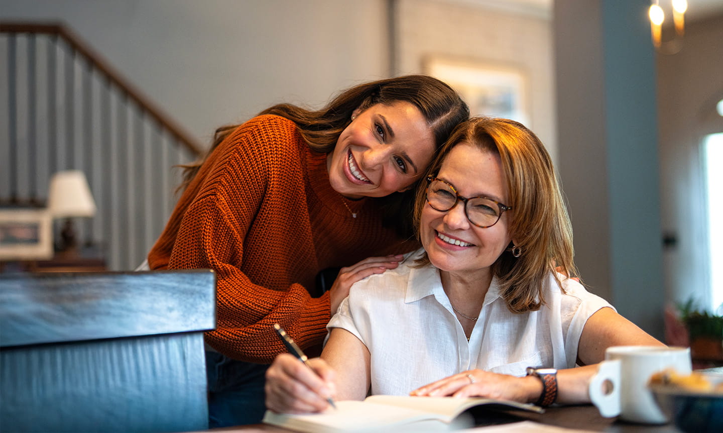 Mom and daughter signing paperwork