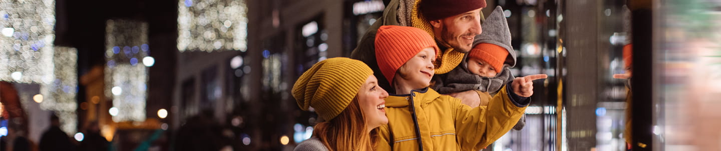 Family embracing while window shopping