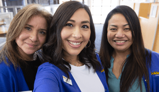 Three smiling Golden 1 employees taking a selfie in a Golden 1 branch