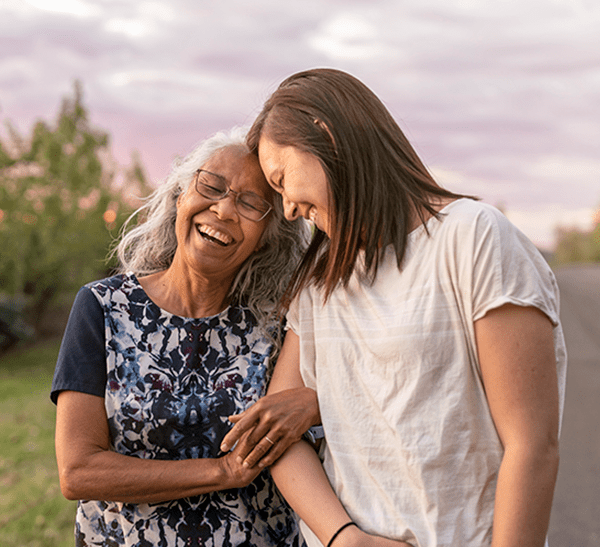 Mom walking hand in hand with daughter outside