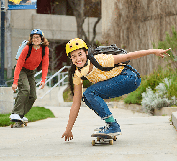 Students skateboarding on college campus
