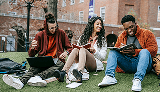 Three students studying outside together