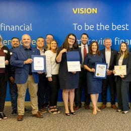 Golden 1 employees posing for photograph holding certificates