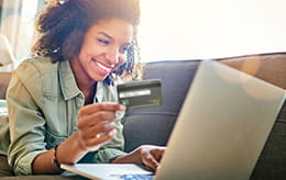 woman using her platinum rewards card on her laptop