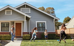 Family playing in front yard