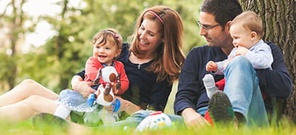 couple with young children in a park