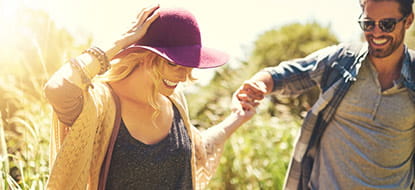 Carefree couple walking in the sun