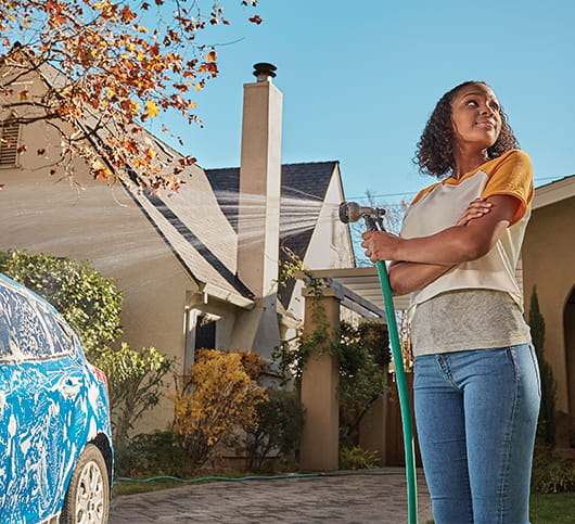 young woman washing her new car