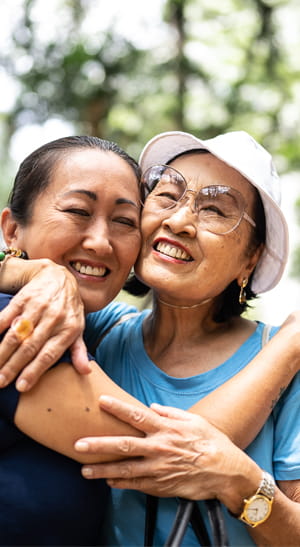 A mom and daughter hugging,