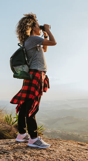 Woman looking through binoculars.
