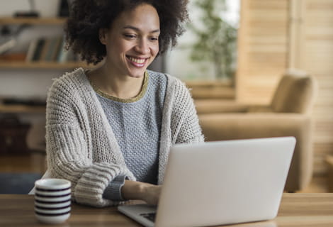 young woman works on laptop