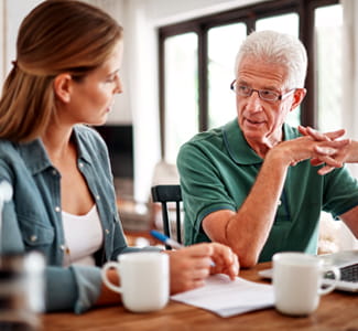 daughter and mature father going over paperwork